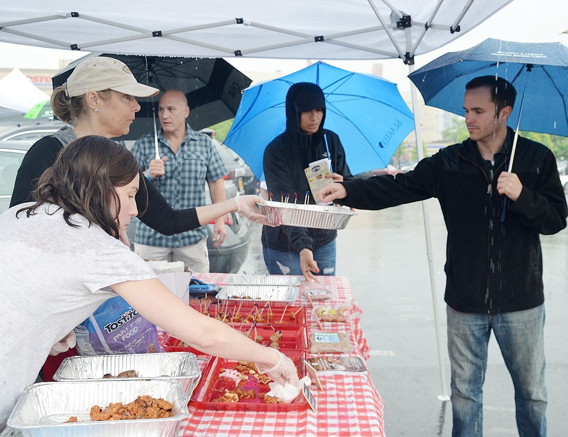 <p class="Picture">Despite the rain, Hudson Valley Craft Sausage, located at 72 Grace Church St., serves up samples of their homemade Italian sausage and chorizo in the marina parking lot off Abendroth Avenue.&nbsp;</p>