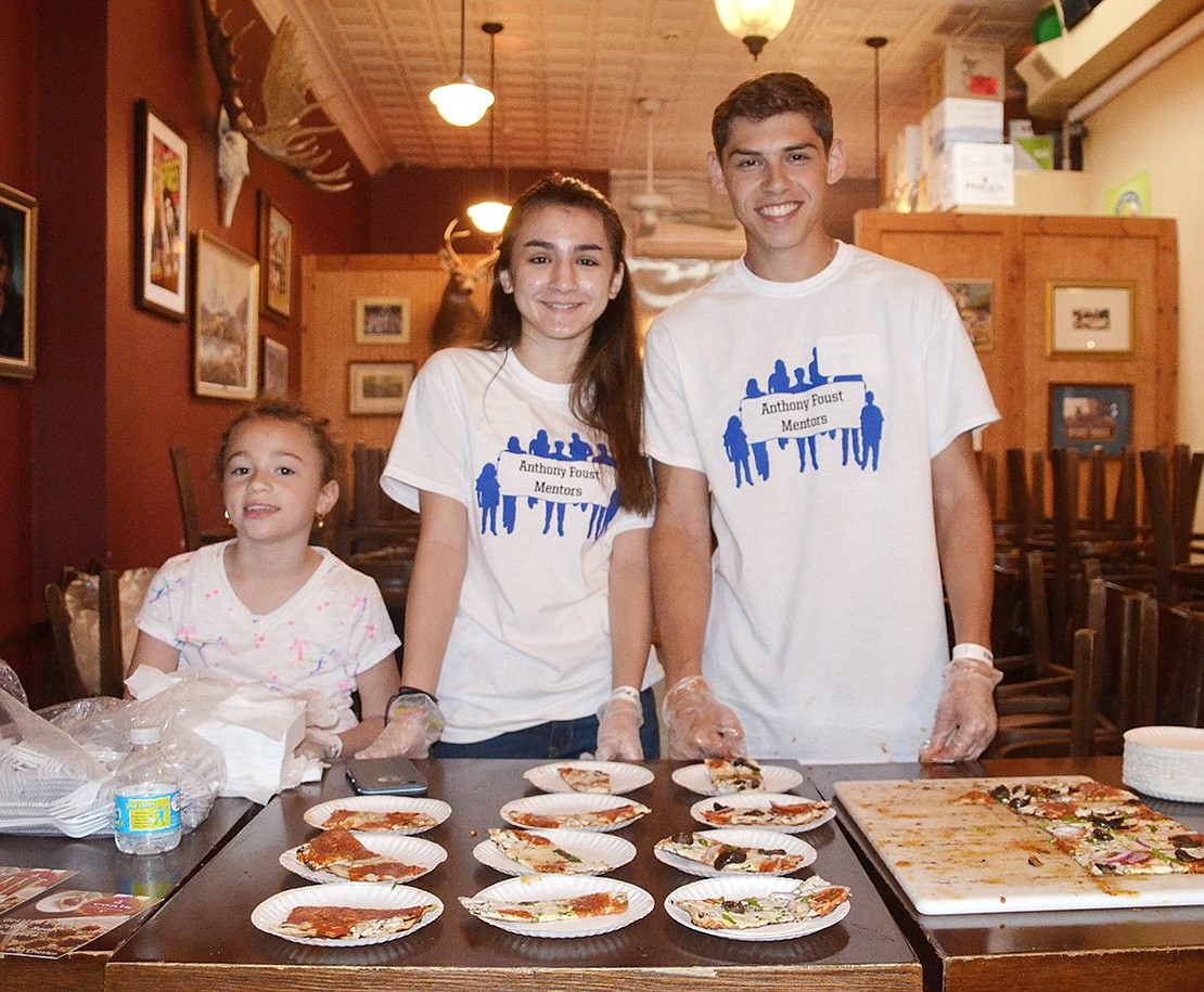 <p class="Picture">Gabriella Sculky (left), a Park Avenue School first grader, Allaire Matturro, a Port Chester High School sophomore, and Leonard Pietrafesa, a Port Chester High School senior, passed out a variety of grilled pizzas at Coals on North Main Street.&nbsp;</p>