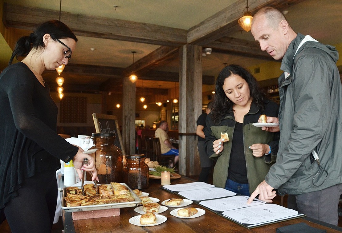<p class="Picture">Scott Simonsen (right) of Port Chester and Karilyn Castro of New Jersey check out the menu at Rye House while snacking on the North Main Street restaurant&rsquo;s truffle grilled cheese.&nbsp;</p>