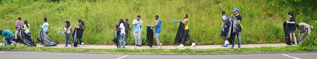 Walking along lower King Street, teenagers pick up garbage Saturday morning.
