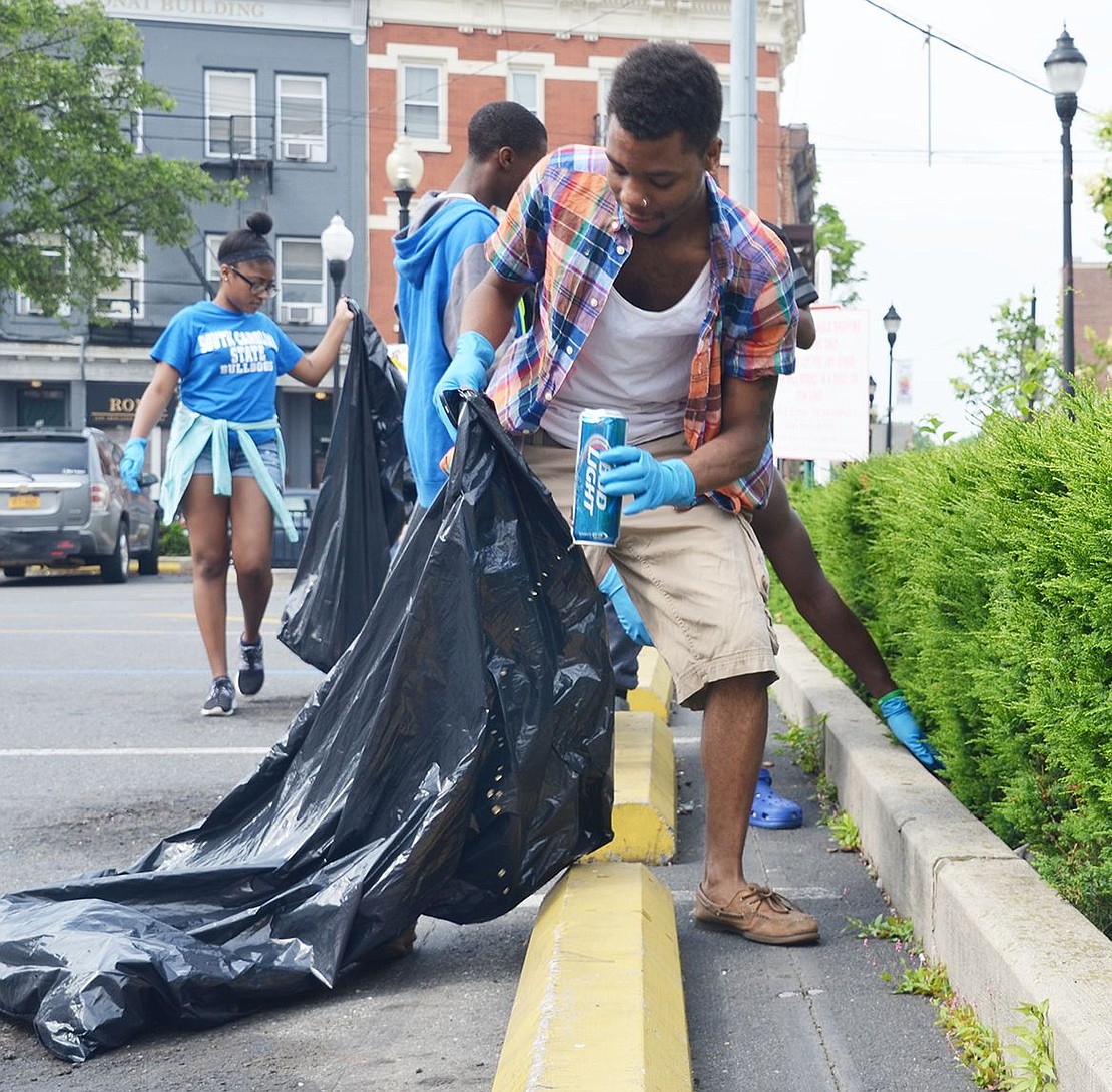 Daiquon Williams, a senior at Port Chester High&nbsp;School, tosses out a Bud Light beer can he found in&nbsp;the bushes lining the parking lot of Walgreens on&nbsp;North Main Street.
