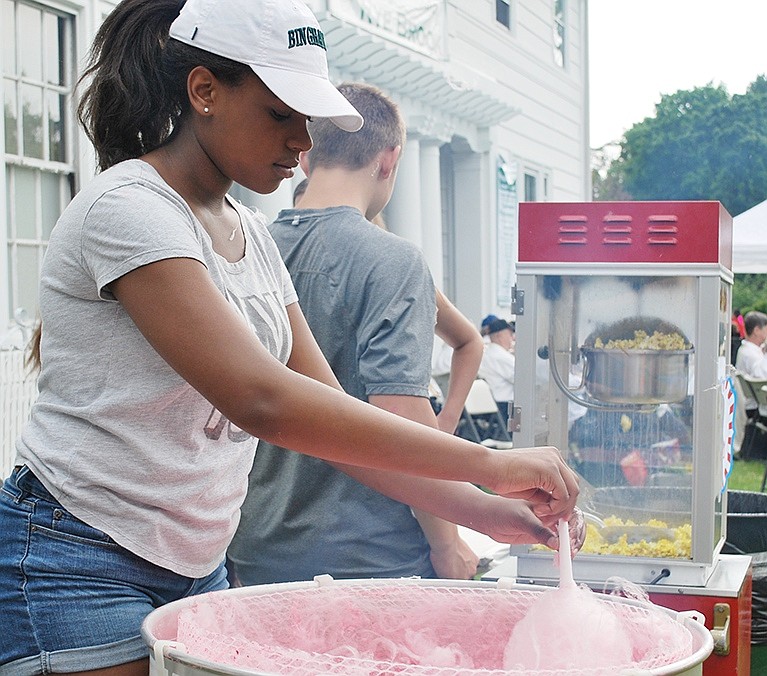 <p class="Picture">Blind Brook High School freshman Joelle Maitland makes cotton candy for a young customer.</p>