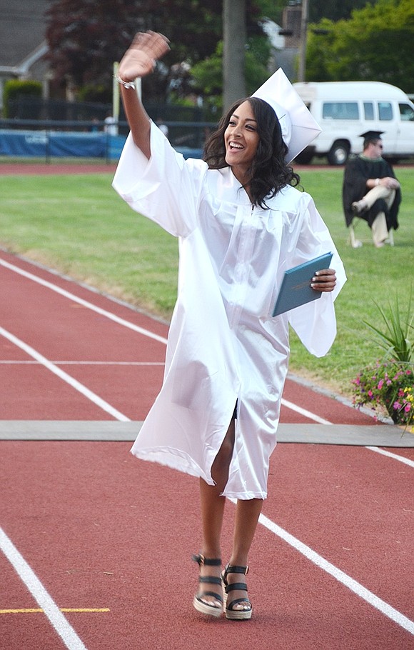 <p class="Picture">Scarlin Ponceano waves to friends and family in the stands after receiving her diploma. Richard Abel|Westmore News</p>