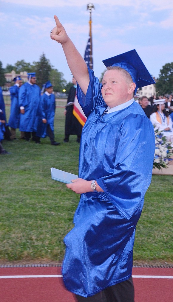 <p class="Picture"><span style="font-family: Arial, sans-serif;">An animated Michael Lagano points to well-wishers in the stands after picking up his diploma.&nbsp;</span>Richard Abel|Westmore News</p>