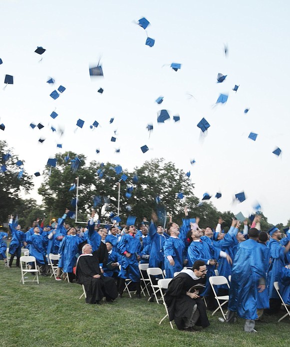 <p class="Picture"><span style="font-family: Arial, sans-serif;">Boys throw their caps into the air after having been declared graduates by Port Chester High School Principal Dr. Mitchell Combs on June 24.&nbsp;</span>Richard Abel|Westmore News</p>