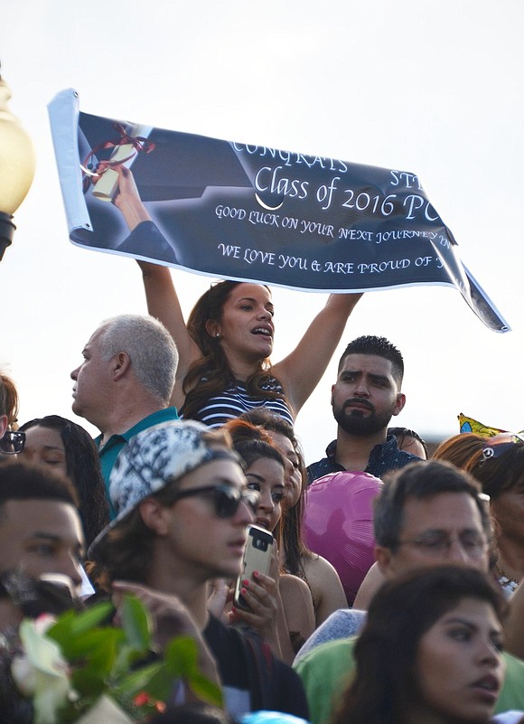 <span style="font-family: Arial, sans-serif;">&nbsp;An audience member in the stands at Ryan Stadium lifts up a large banner congratulating the Class of 2016.</span><br /> <span style="font-family: Arial, sans-serif;">Richard Abel|Westmore News</span>