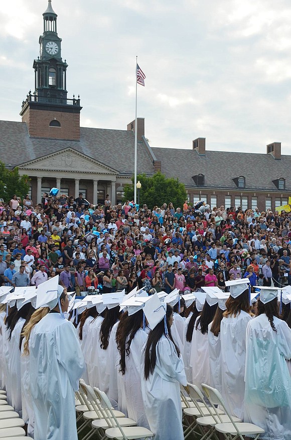 <p class="Picture"><span style="font-family: Arial, sans-serif;">The scene at the Port Chester High School commencement on Friday, June 24 with female graduating seniors wearing white gowns in the foreground and the packed stands at Ryan Stadium in the background.&nbsp;</span>Richard Abel|Westmore News</p>