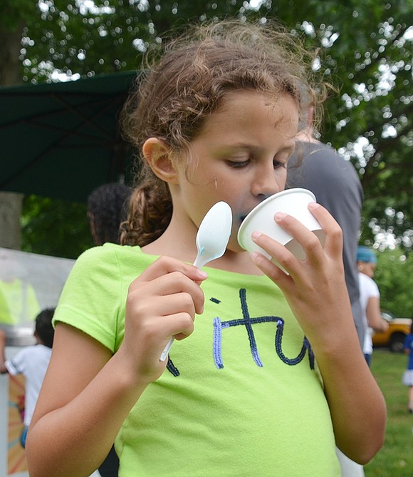 <p class="Text">Cassandra Brunetti, a 7-year-old resident of Windsor Road, dives face-first into her free blueberry ice cream.</p>