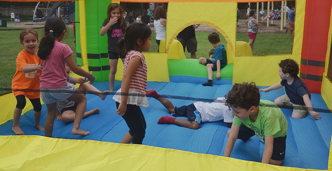 <p class="Picture">Kids bounce away their sugar rush after eating free ice cream in Pine Ridge Park.</p>