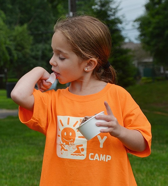 <p class="Picture">Five-year-old Rye Brook resident Emmie Hodes enjoys every last drop of her chocolate ice cream.</p>