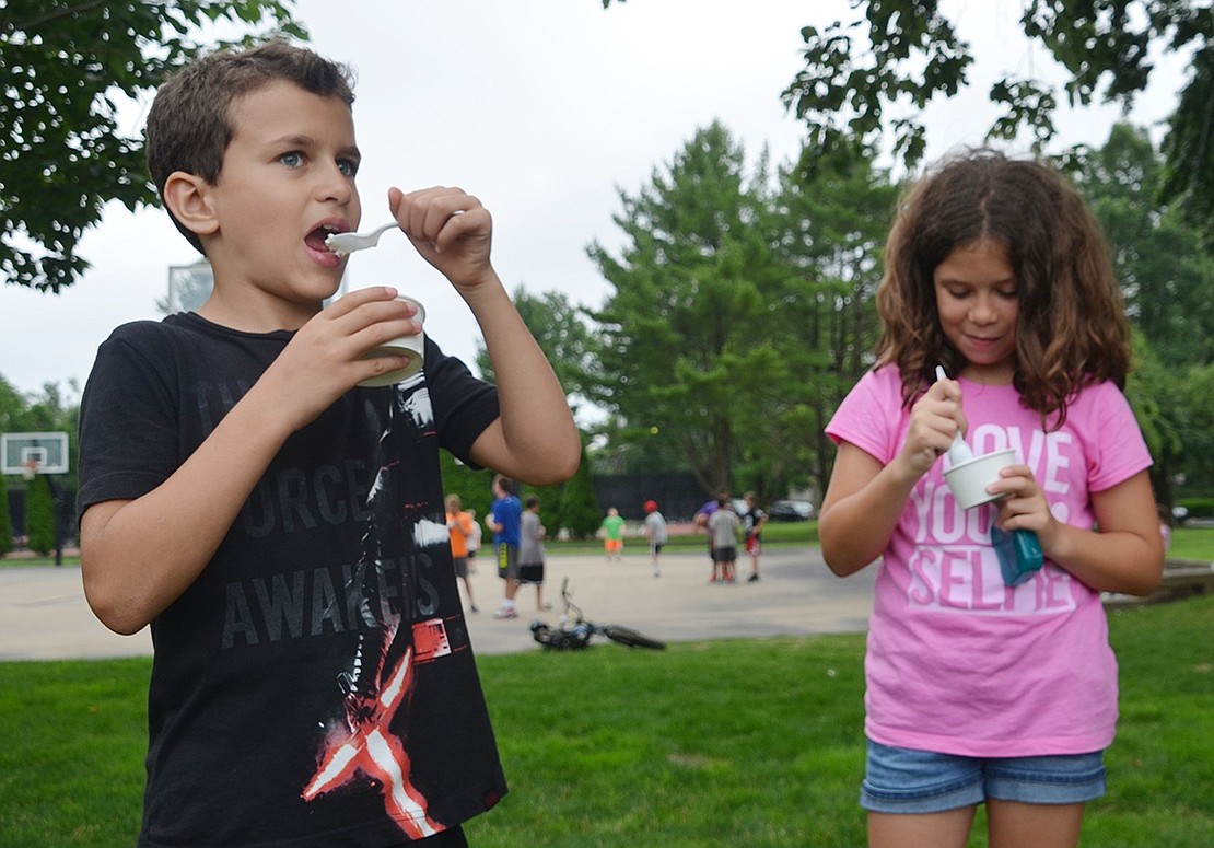 <p class="Picture">Nine-year-old twins Grace and Rocco Brunetti of Windsor Road dig into their ice cream.</p>