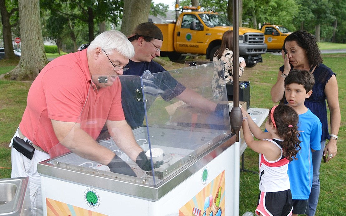 <p class="Picture">Village Administrator Christopher Bradbury gets his hands dirty to serve the Rye Brook community ice cream.</p>