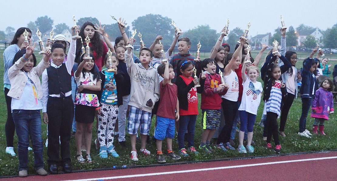 <p class="Picture">Student contest winners from all of the elementary schools in Port Chester and Rye Brook hold up their trophies at the Independence Day celebration at Port Chester High School&rsquo;s Ryan Stadium on Saturday, July 9. With light rain falling, fireworks by Grucci, about seven minutes&rsquo; worth, capped off the festivities.</p>