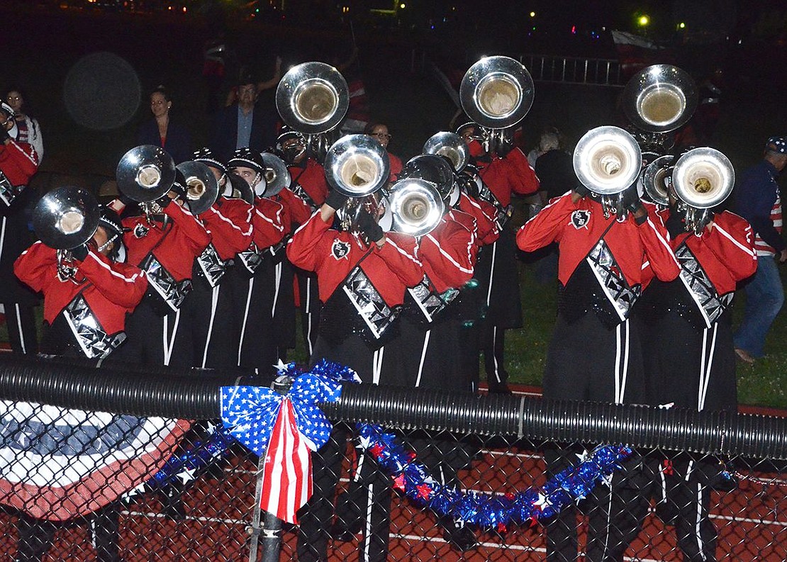 <p class="Picture">Horns stand out as The Saints Brigade Drum &amp; Bugle Corps performs in the dark.</p>