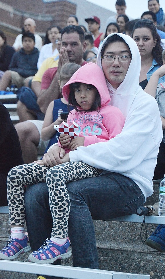 <p class="Picture">Ying Hao Wu of James Way holds 6-year-old daughter Melody in the stands.</p>