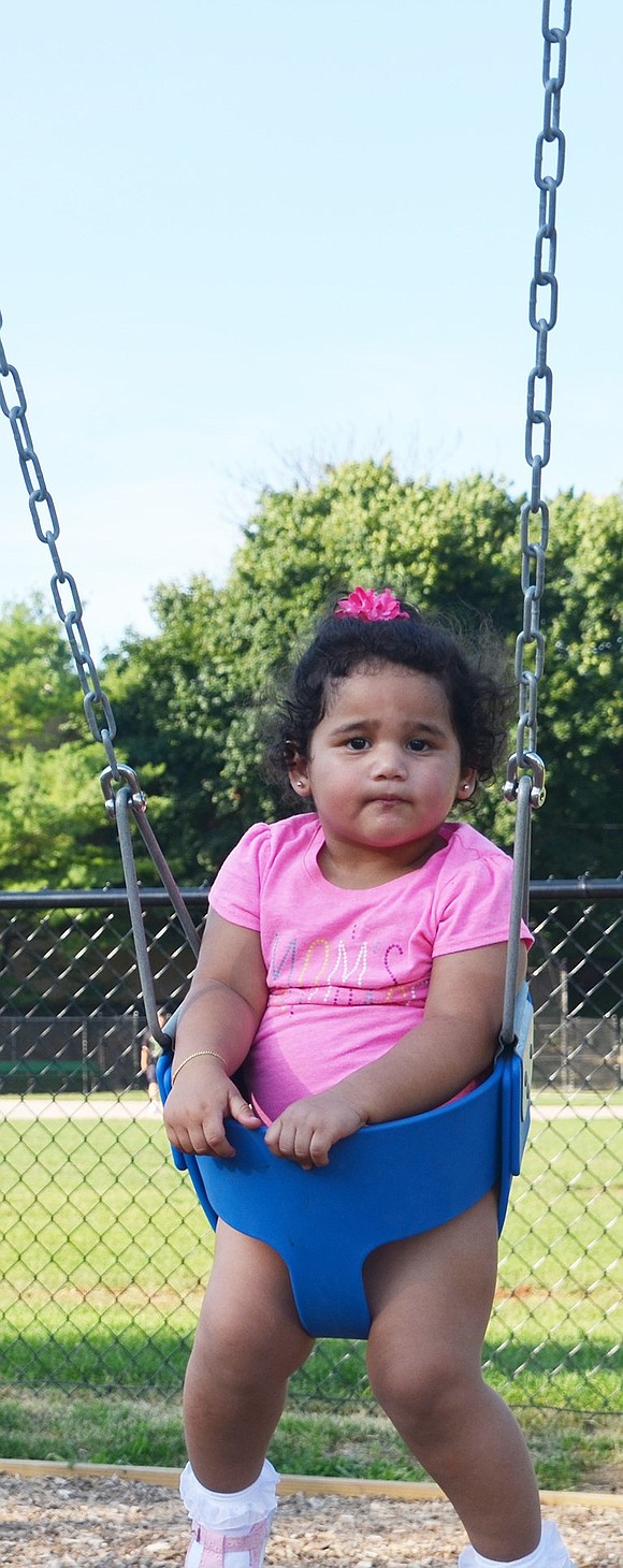 <p class="MsoNormal">Daniela Sanchez, a 21-month-old Port Chester resident, enjoys her time outside being pushed by her mother and father on the new swing set.&nbsp;</p>