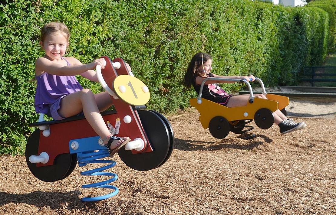 <p class="MsoNormal">Danielle Elkowitz, 6, and Michelle Simkin, 11, race to see who can rock the hardest on the new spring rider cars.</p>