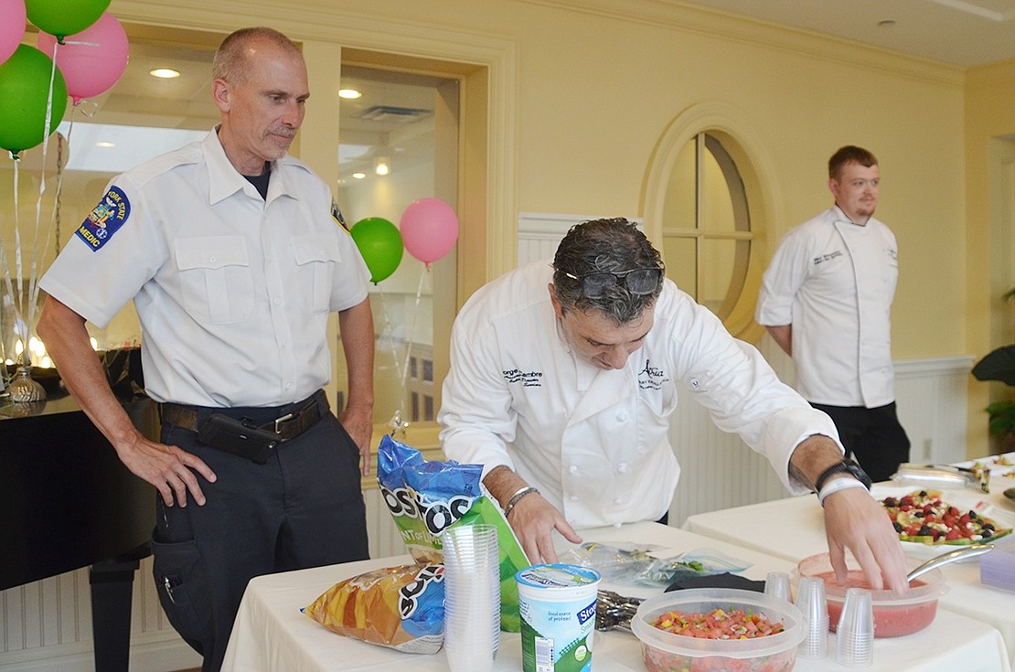 <p class="Picture">EMS Administrator Scott Moore and Atria Rye Brook Chef Jorge Cambre prepare the food before it is served to Atria residents and judged on what dish is best and who is the better chef.&nbsp;</p>