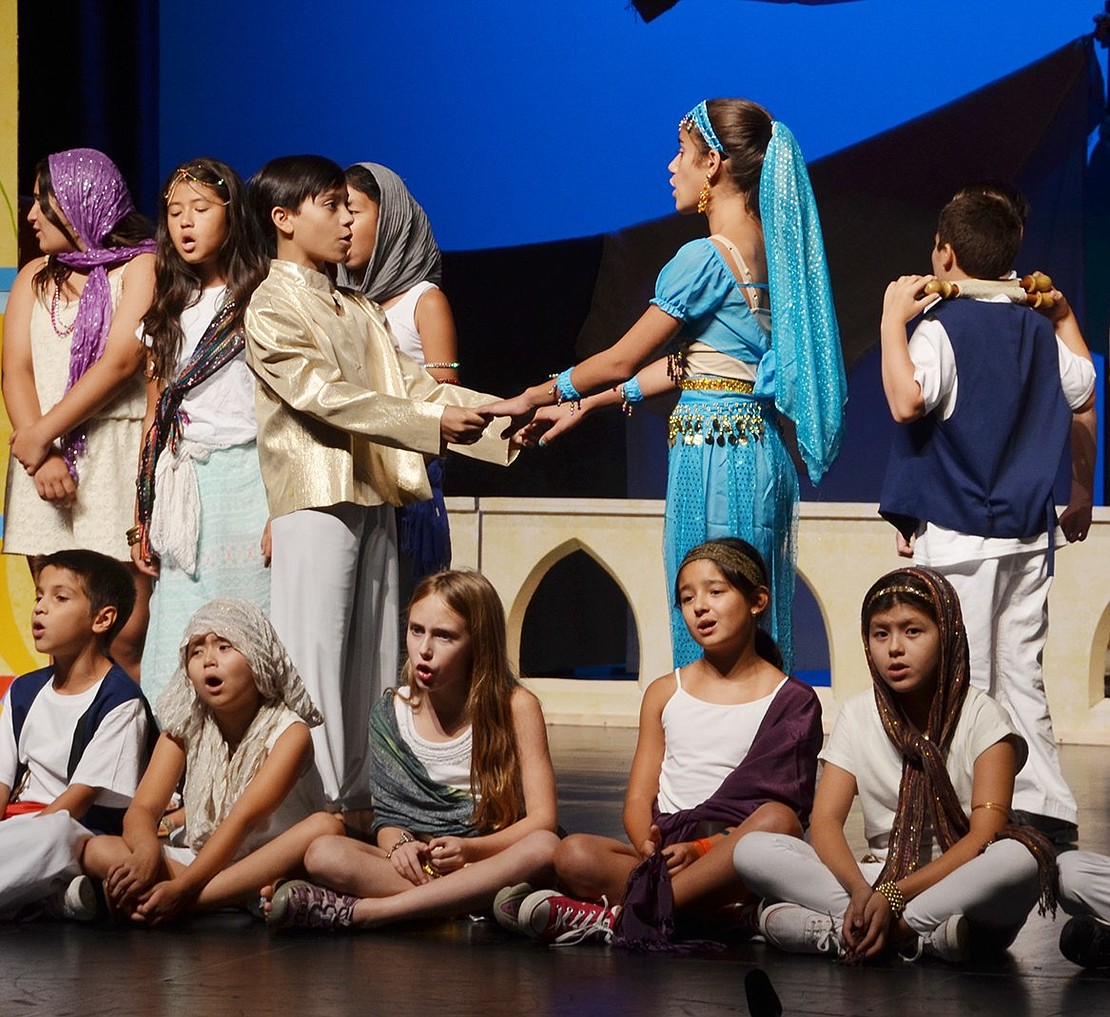 <span style="font-family: Arial; font-size: 13px;">Aladdin, played by Kyle Arzaga, and Princess Jasmine, played by Rye Brook resident Alyssa Bucci, hold hands as they are wed in front of the kingdom of Agrabuh.&nbsp;Casey Watts|Westmore News&nbsp;</span>