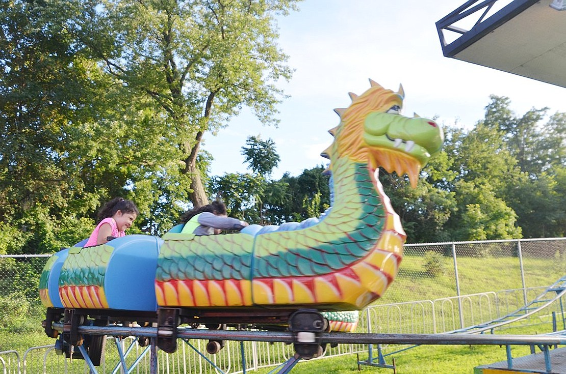 <p class="Picture">Port Chester residents Isabella, 5, and her older sister Gisewe Nova, 6, hang on for their lives on the dragon-themed kiddie rollercoaster.&nbsp;</p>