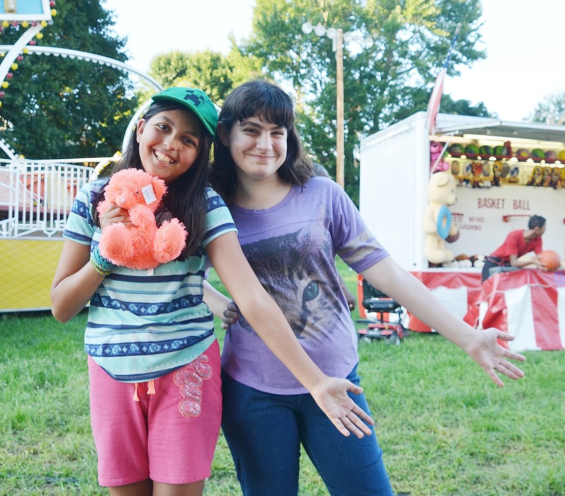 <p class="Picture">Port Chester residents Krista Morlino, 12, and her friend, 13-year-old Marjorie Candreva, pose after Morlino won an orange bear while playing the Whack-A-Mole game.&nbsp;</p>