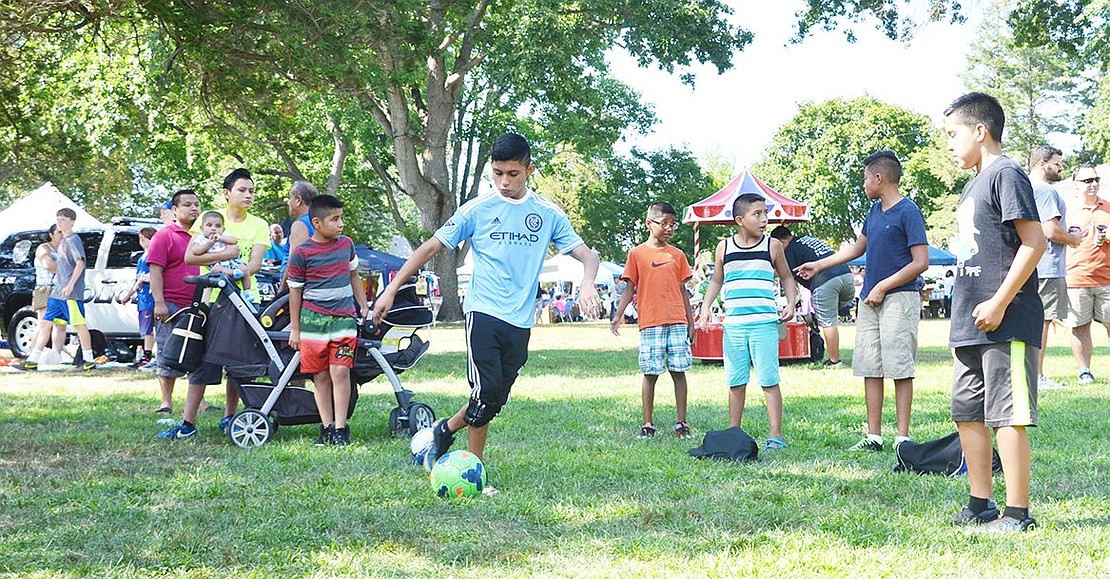 <p class="Picture">A group of young boys show off their soccer skills, shooting goals into an inflatable course with targets.&nbsp;</p>