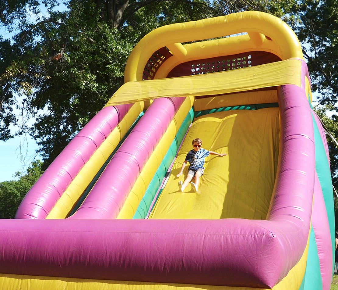 <p class="Picture">Puritan Drive resident Scott Sullivan, 9, looks cool in his sunglasses as he glides his way down the slide. </p>