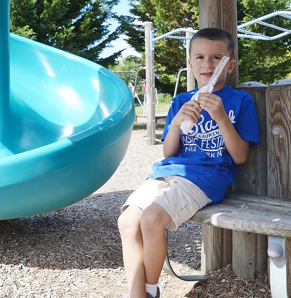 <p class="Picture">Vincenzo Conte, 5, of Rye Brook shows his displeasure about being outside on a hot day as he sits in the only shaded area near the slides.&nbsp;<span style="text-decoration: underline;"></span></p>