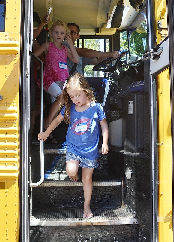 <p class="Picture">Five-year-old Hayden Candee of Fellowship Lane watches her step as she gets off her first-ever school bus ride. On the last step, the brave little girl squatted down and jumped to reach the sidewalk.&nbsp;</p>