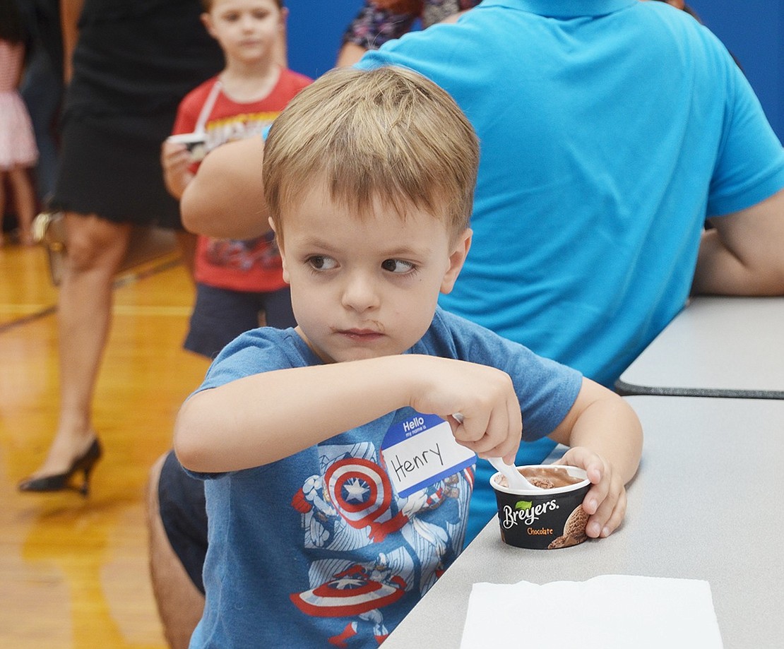 <p class="Picture">Henry Urbania, 5, of Locust Avenue eyes the kids hula hooping on the other side of the King Street School gym.</p>