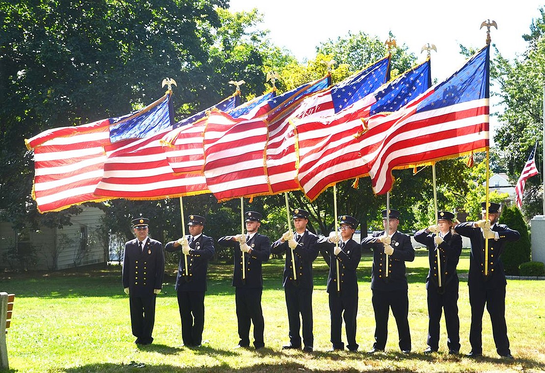 <p class="Picture"><span style="font-family: Arial;">At left, the color guard captain stands with seven other members of the Port Chester Fire Department, representing the seven volunteer companies, as they present the American flag. </span></p> <span style="font-family: Arial;"> Casey Watts|Westmore News</span>