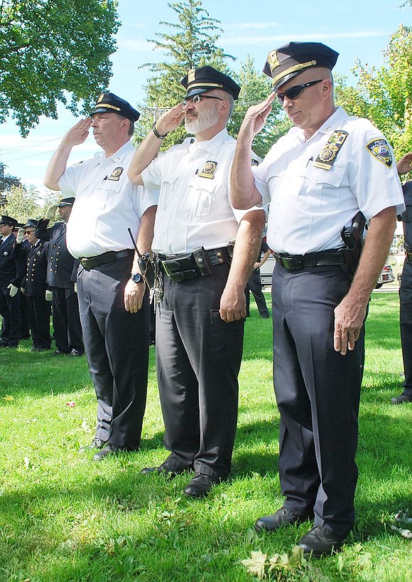 <p class="Picture"><span style="font-family: Arial;">Port Chester Police Lieutenant Charles Nielsen, Captain Christopher Rosabella and Chief Richard Conway salute the flag.</span></p> <span style="font-family: Arial;"> Richard Abel|Westmore News</span>