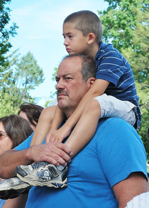 <p class="Picture"><span style="font-family: Arial;">Sam Giordano gives his 5-year-old son Santo a boost so he can see and learn about Sept. 11, 2001 during the ceremony.</span></p> <span style="font-family: Arial;"> Richard Abel|Westmore News</span>