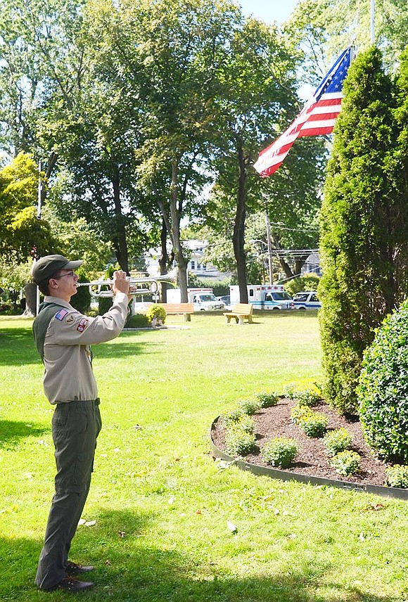 <p class="Picture"><span style="font-family: Arial;">Port Chester Boy Scout Troop 400 bugler William Brakewood, 15, plays &ldquo;Taps.&rdquo; The sad melody echoed throughout the silent park.</span></p> <span style="font-family: Arial;"> Casey Watts|Westmore News</span>