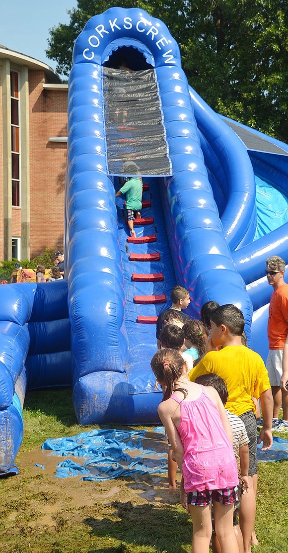 <p class="Picture">The Corkscrew slide, manned by Port Chester Board of Education member Chris Wolff, was the most popular activity for kids because it required them to get wet.</p>