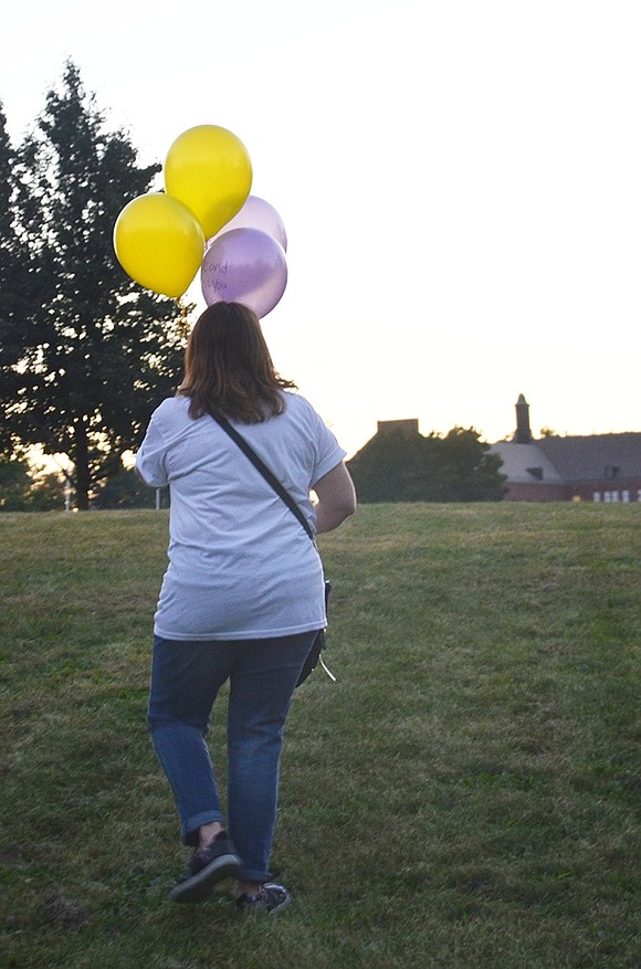 <p class="Picture">Ginger Acevedo makes her way to the top of the hill next to Park Avenue School with messages for her daughter written on yellow and purple balloons. She lost Gabby when she was 21. The soon-to-be college graduate died in a car accident on Feb. 4, 2011. &ldquo;We always remember,&rdquo; Acevedo said. &ldquo;That&rsquo;s why we&rsquo;re here. They are the first thing you think about when you wake up and the last thing before you go to bed.&rdquo;&nbsp;</p>