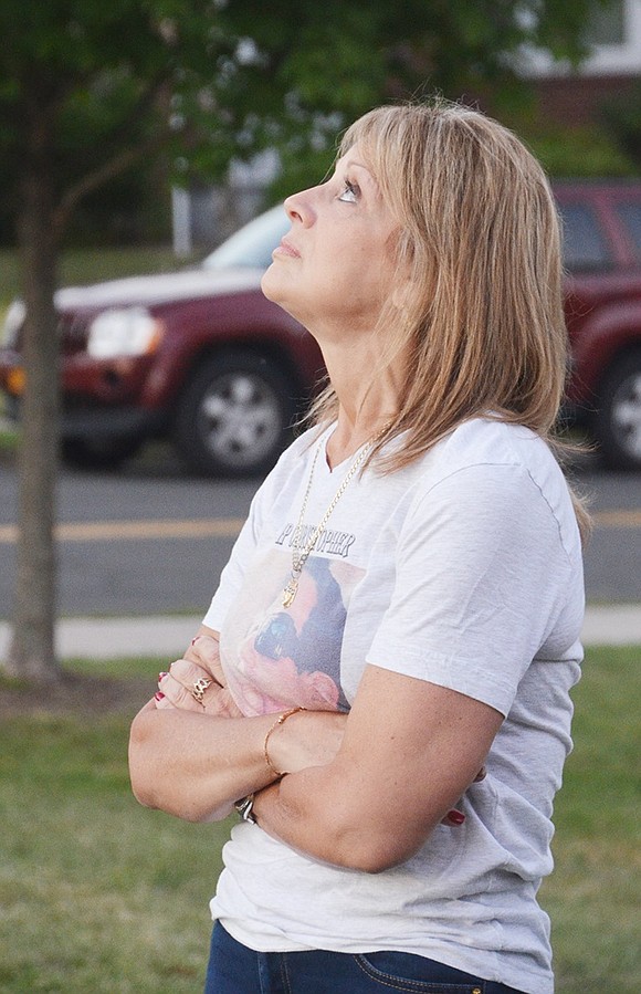<p class="Picture">Maria Seguinot looks to the sky after blowing a kiss to her son, Christopher. He was 21 when he died on July, 20, 2014 in a car accident. He attended Harrison High School.&nbsp;</p>
