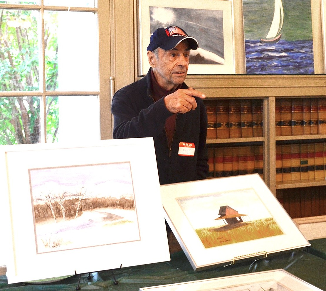 <p class="Picture">Bart Lombardi of Guilford, Conn. explains his paintings of landscapes to interested parties.&nbsp;</p>