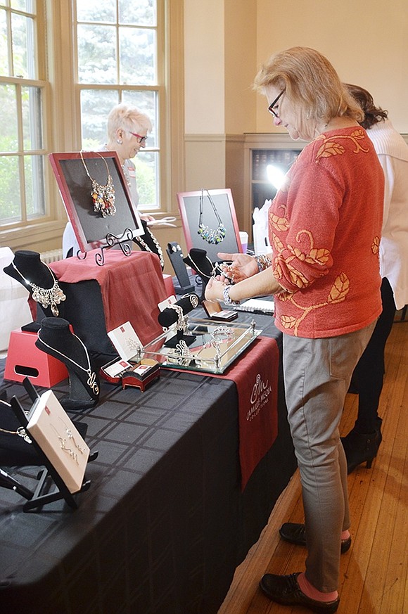 <p class="Picture">Co-chair of ART10573, Sue Covino of Leicester Street, browses Camille Meola&rsquo;s selection of silver-plated jewelry. A bracelet caught Covino&rsquo;s eye and she slipped it on her wrist to see how it fit, at ART10573 in Crawford Park Mansion on Sunday, Oct. 2.&nbsp;</p> <p class="Byline">Photo Story By Casey Watts</p>