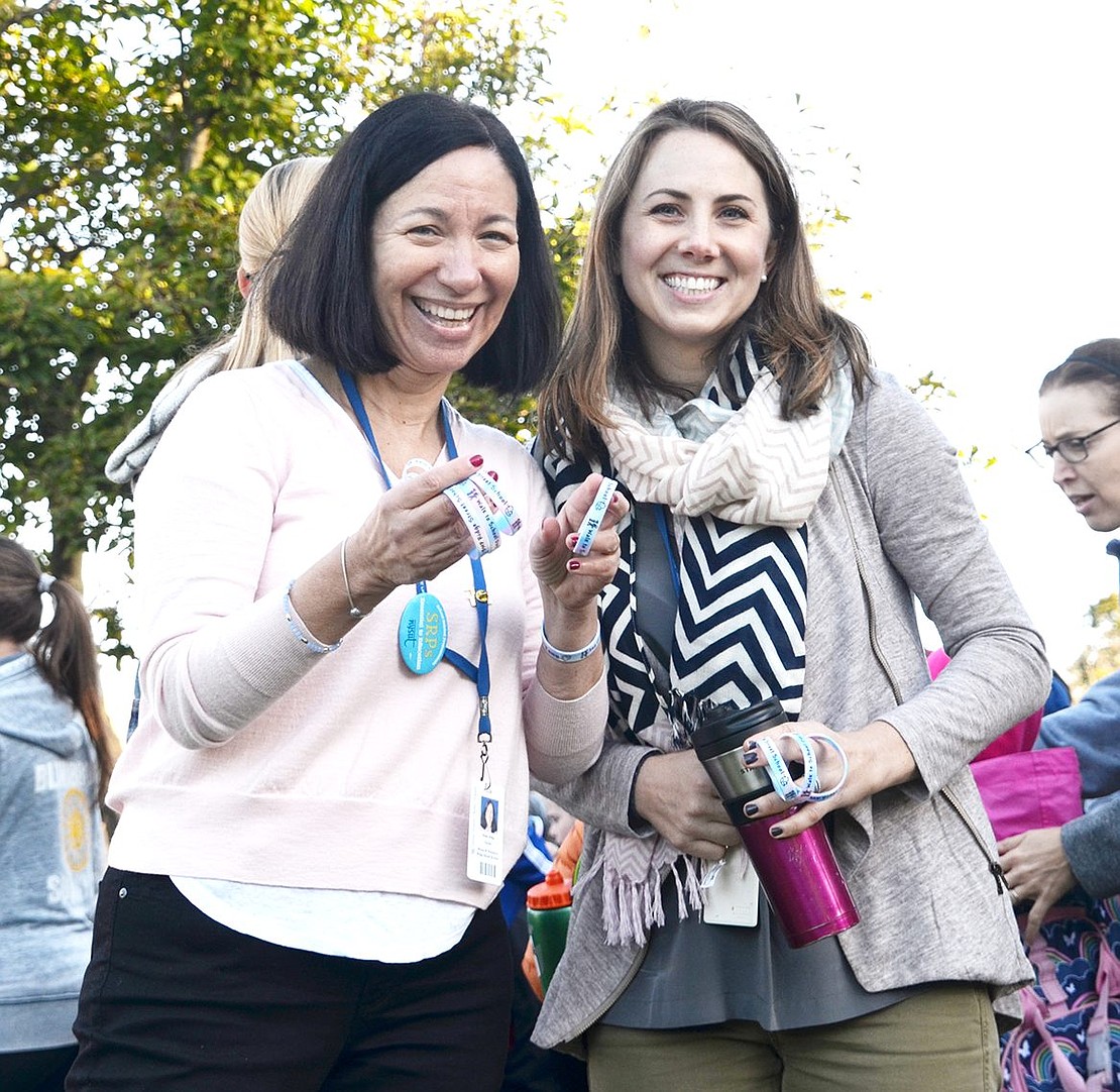 <p class="Picture">STEAM (science, technology, engineering, arts and math) teacher Robin Willig and special education teacher Shannon Rudd volunteered to help out and gave bracelets to all the students who walked to school.&nbsp;</p>