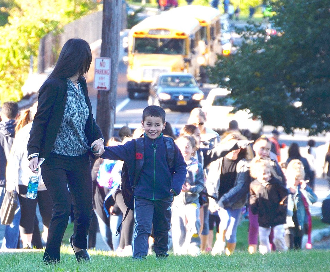 <span style="font-family: Arial;">Someone has to lead the large crowd across the school yard and this boy did it with a big smile on his face.&nbsp;</span>About 300 parents and children walked to Ridge Street School on Oct. 5 to celebrate International Walk to School Day.<span style="font-family: Arial;"><br /> </span> <p class="Byline">Photo Story By Casey Watts</p>