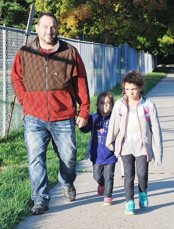 <p class="Picture">Vincent, second grader Marisa and kindergartner Charlotte Rachiele walk to school from Hawley Avenue.</p>