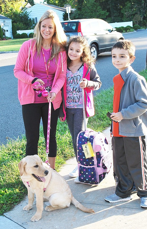 <p class="Picture">The Pirias&rsquo; yellow lab puppy Kayla was a big hit at the event. They are Sara, fourth grader Lucianna and second grader Dominic. The family arrived at school on foot from Halstead Avenue.</p>