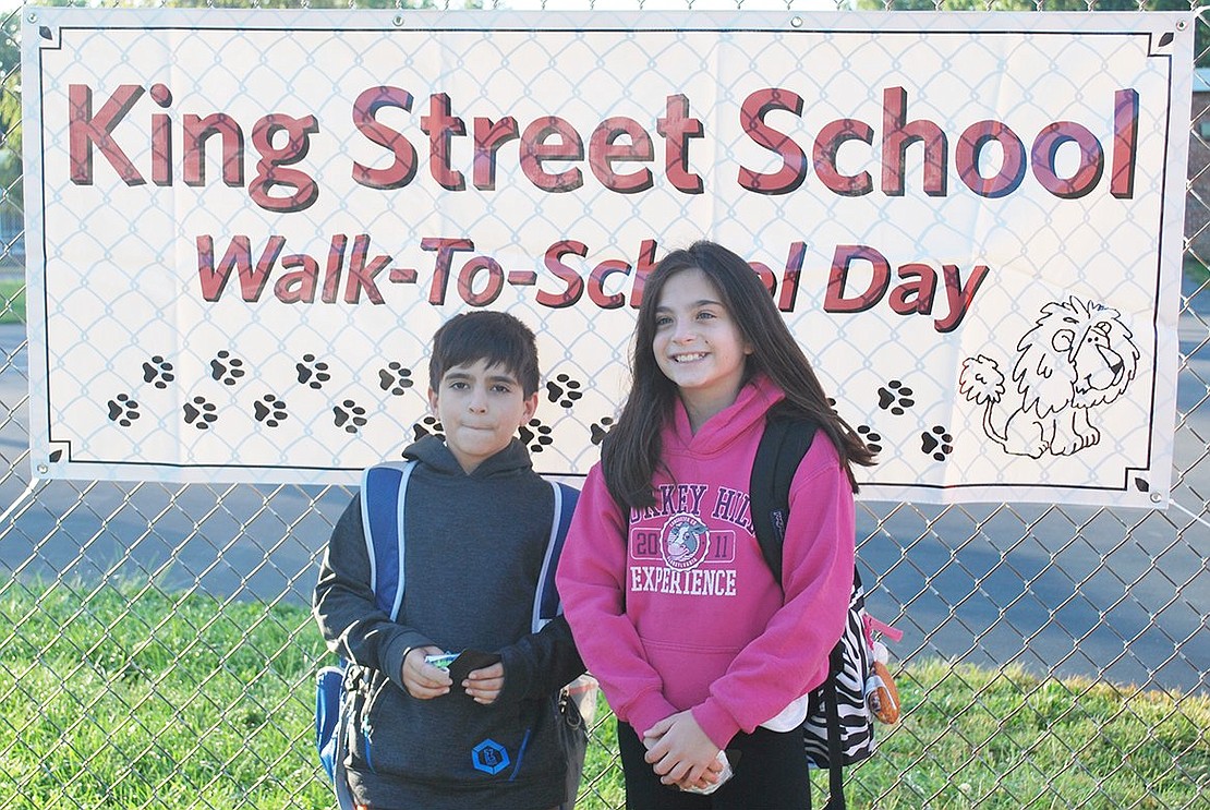 <p class="Picture">Fifth grader Jessica Sachs and her brother Bryan, a third grader, stand in front of the King Street School Walk to School Day sign for a picture after walking to school with their babysitter and her dog Max from Munson Street. They were among the hundreds of students, parents and caregivers who took part in King Street School&rsquo;s International Walk to School Day event on Wednesday, Oct. 5.</p> <p class="Picture">Photo story by Jananne Abel</p>