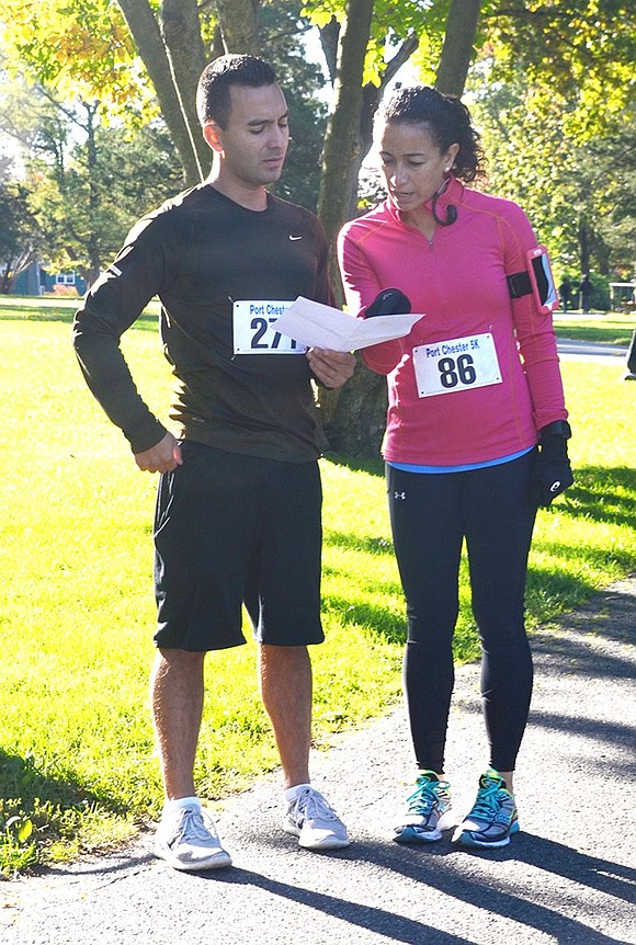 <p class="Picture">Brother and sister team Kabir Valencia of White Plains and Karen Valencia Wright of King Street, Rye Brook, familiarize themselves with the map before the run.&nbsp;</p>