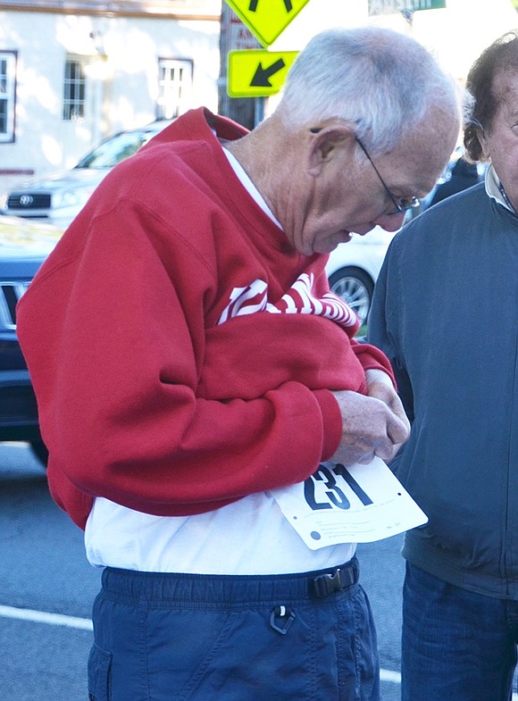 <span style="font-family: Arial;">Don Davis of Tower Hill Drive pins his number on his shirt in preparation for the 5K race. &nbsp;</span>