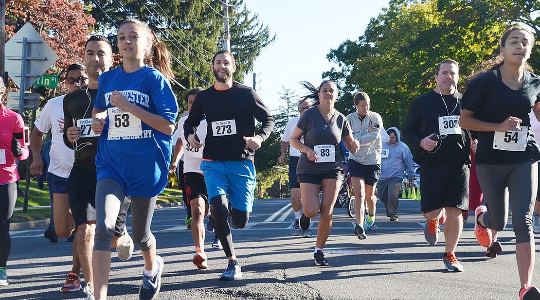 <p class="Picture">Led by Port Chester police and white arrows on the road, 27 runners participate in the 18<sup>th</sup> Annual Port Chester 5K Fun Run/Walk on Saturday, Oct. 15. Five kilometers is roughly 3.1 miles. It took runners about 17-40 minutes to complete the run/walk which started and ended at Lyon Park. Photo Story By Casey Watts</p>