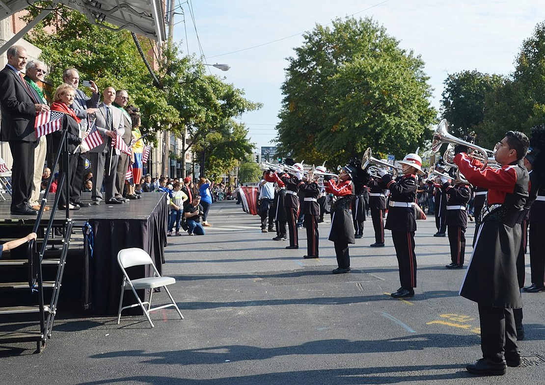 <span style="font-family: Arial;">The Saints Brigade Drum &amp; Bugle Corps play in front of the reviewing stand.</span>