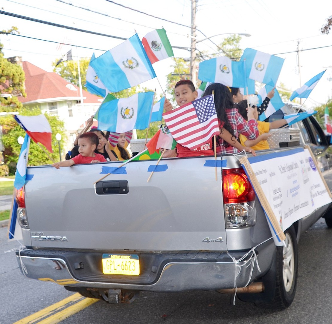 <p class="Picture">Kids representing Port Chester&rsquo;s St. Peter&rsquo;s Episcopal Church wave diverse countries&rsquo; flags from the back of a pickup truck.</p>