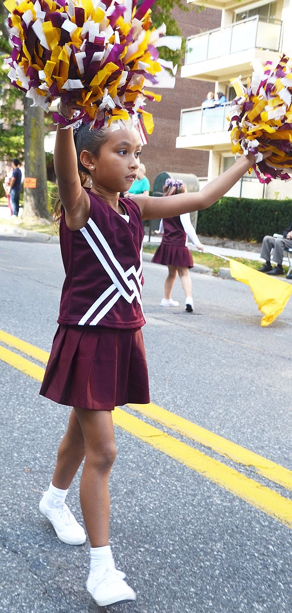 <p class="Picture">King Street School third grader Aaliyah Flecha shakes her pom poms as she marches.</p>